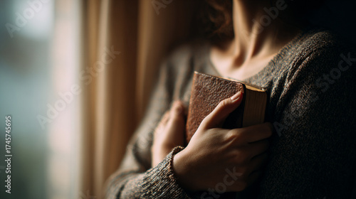 Woman Holding Bible to Chest in Prayer and Faith