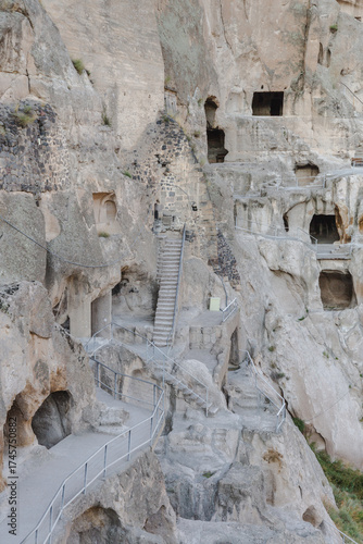 Wallpaper Mural View of ancient cave monastery carved into the rugged mountainside, showcasing a network of pathways, stairs, and openings, Vardzia, Imereti, Georgia. Torontodigital.ca