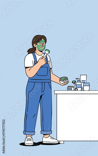 Woman with green facial mask holding a jade roller standing near a table with skincare products