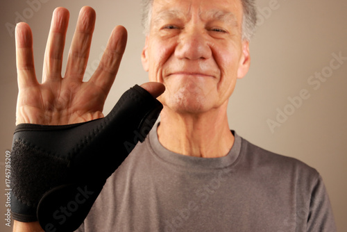 Man wearing a Black Wrist and Thumb Support Brace for Arthritis and Thumb pain