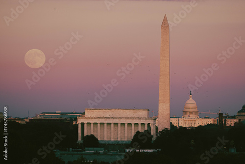 Full moon rising over Lincoln memorial, Washington monument and US Capitol building. 