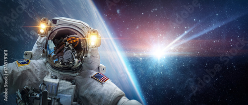 Fototapeta Naklejka Na Ścianę i Meble -  Astronaut in orbit of planet Earth against the background of a falling meteorite. Glowing comet, meteor, meteorite   threatening the safety of the Earth. Elements of this image furnished by NASA.