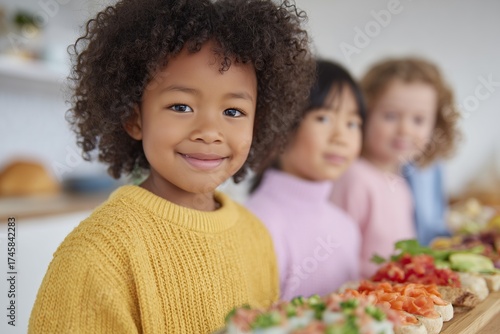 Diverse group of kids exploring colorful global snacks at bright modern kitchen island in daylight