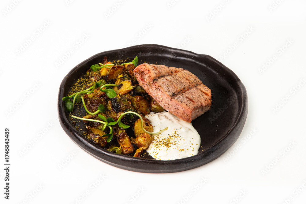 Fototapeta premium Grilled tuna steak with roasted vegetables and creamy sauce