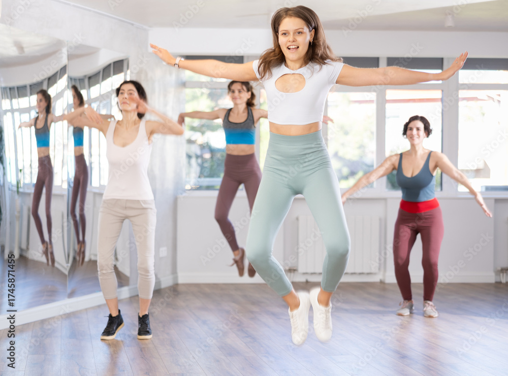 Fototapeta premium Group of women dancing energetic modern dance in studio