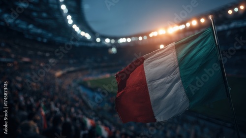 Excitement grows as fans wave the Italian flag during a match at a lively stadium in the evening light