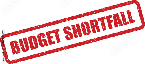 Grungy red rectangular rubber stamp showing the crucial phrase BUDGET SHORTFALL for financial planning or reporting