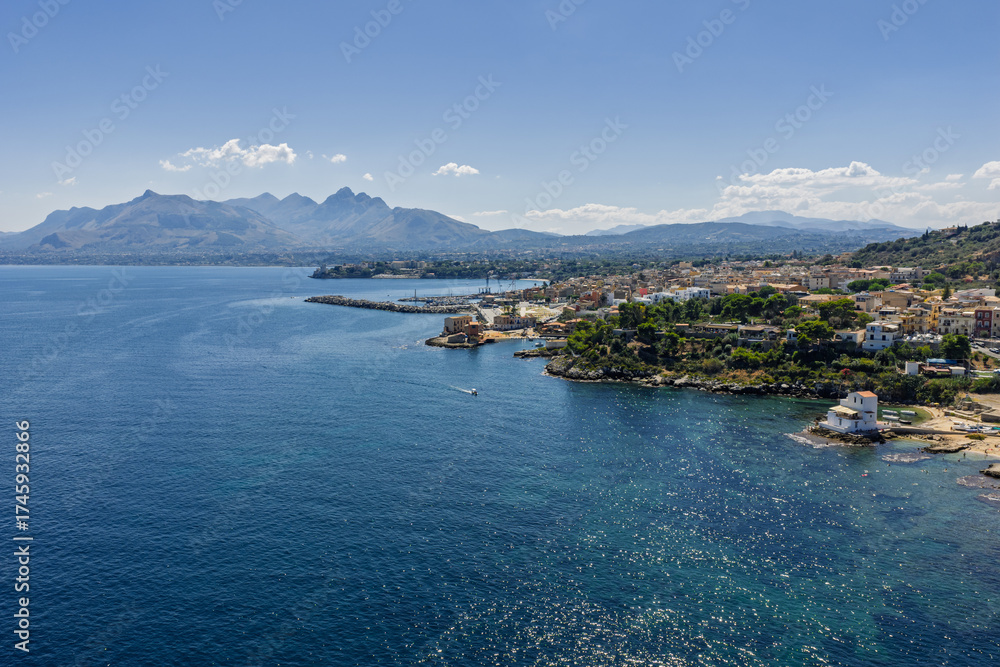 Obraz premium Sant Elia bay beach in Porticello town, Santa Flavia, Sicily, Italy, aerial drone view of Sicilian turquoise waters, rocky cliffs, colorful houses, and Mediterranean coastline panorama in Bagheria