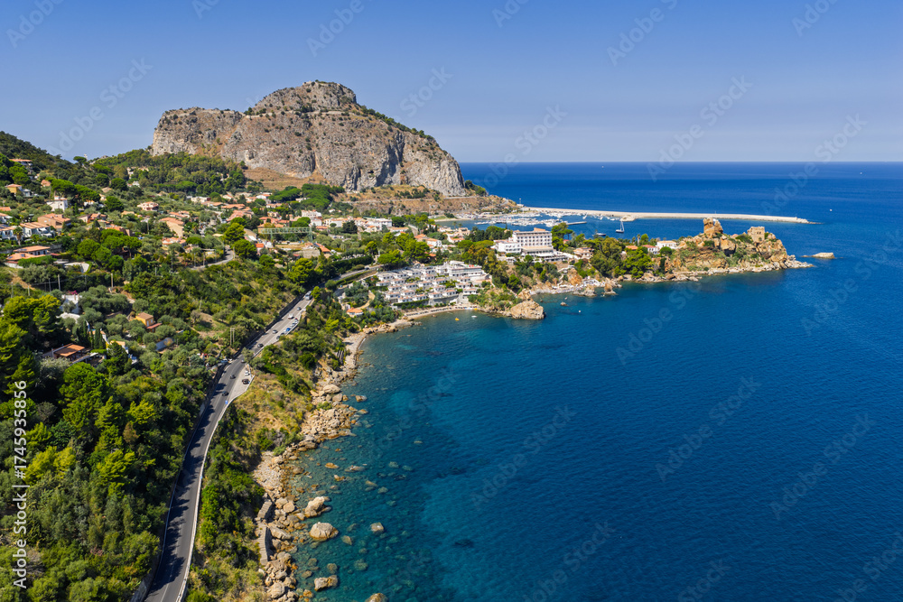 Fototapeta premium Aerial drone view of Scalette Beach in Cefalu, Sicily, Italy. the Tyrrhenian Sea, Capo Cefalu Lighthouse, rocky cliffs, Cefalu Harbor, and medieval castle ruins with scenic coastline panorama