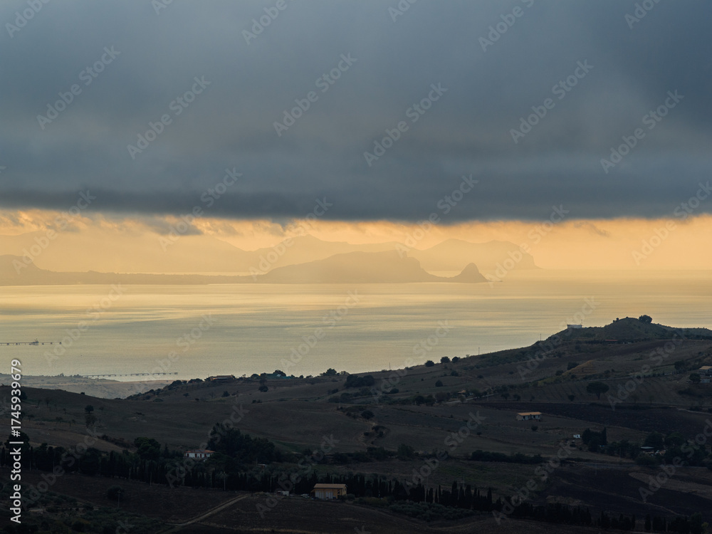 Fototapeta premium Aerial drone view of Capo Zafferano, a scenic Sicilian coastal promontory in the Metropolitan City of Palermo, Italy, featuring distant views of the Tyrrhenian Sea and the majestic Madonie Mountains