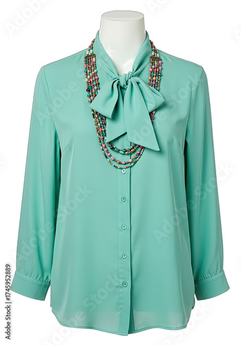 Elegant mint blouse with a bow and beaded necklace on a mannequin displayed fashionably