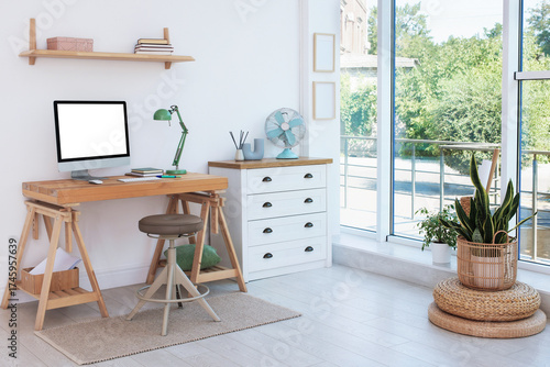 Comfortable workplace at home. Desk with computer in room