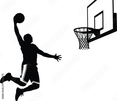 Silhouette of a Basketball Player Performing a Slam Dunk Near the Hoop
