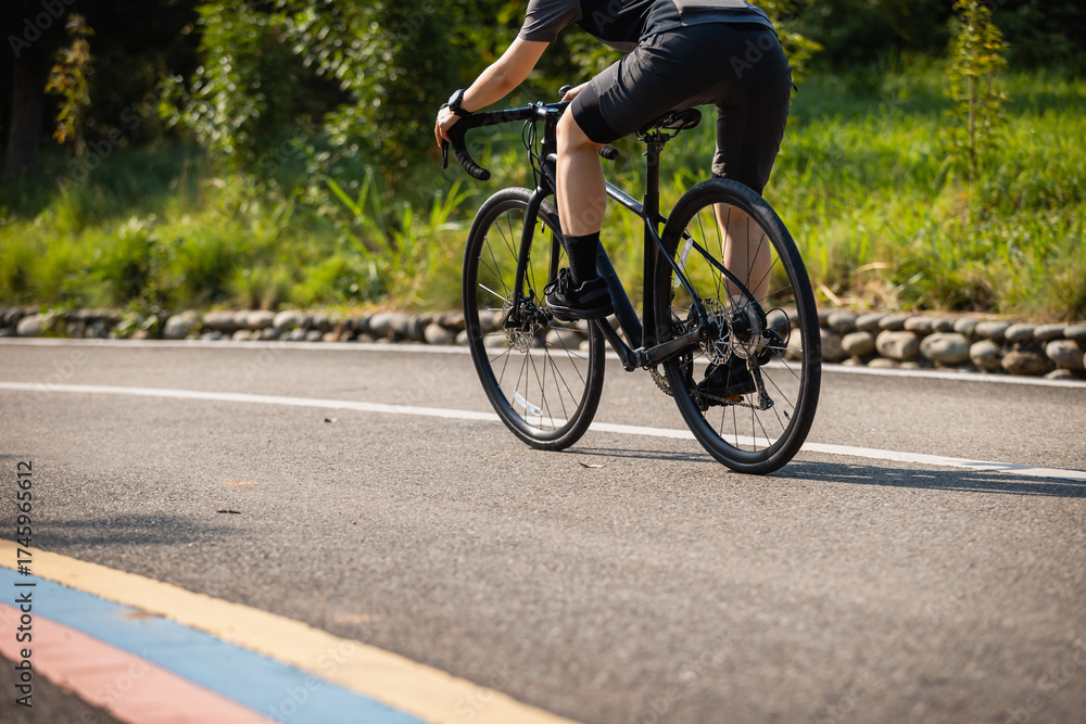 Fototapeta premium Cyclist riding bike at summer park