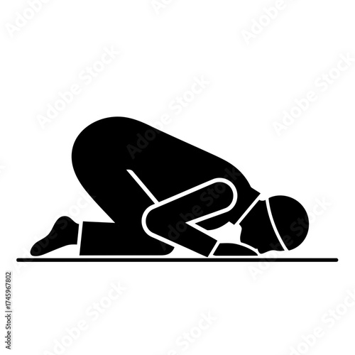 Silhouette of a muslim man praying in the traditional islamic posture of sujood