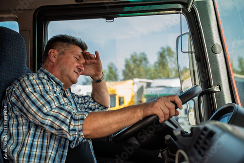 Truck driver tired of everything, or messed up something. Holding one hand on the forehead with disbelief on his face 
