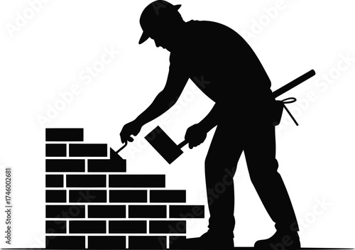 Silhouette of a bricklayer skillfully building a wall with a trowel