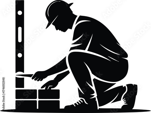 Skilled mason in silhouette meticulously laying bricks with a level tool
