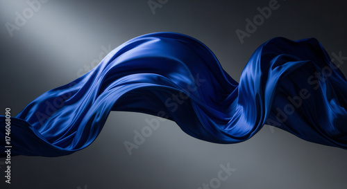 Elegant, flowing blue silk fabric suspended in mid-air with graceful curves and soft, muted tones.