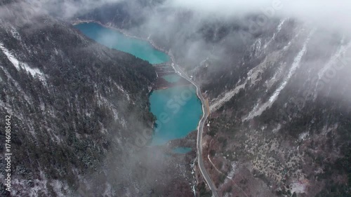 Drone view of Jiuzhaigou National Park in spring in Sichuan Province China. It features cascading waterfalls, turquoise blue lakes, and stunning mountain valleys. 4K real time footage travel concept.