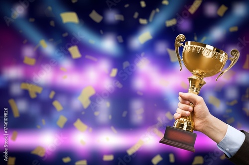 Hand holding golden Trophy cup, Victory concept
