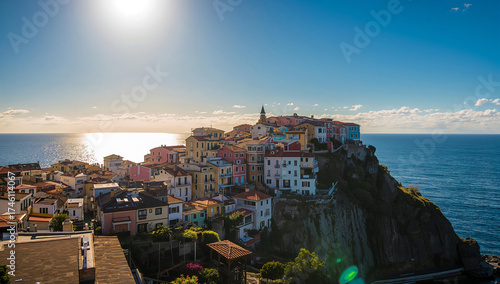 Scenic Coastal Town on Cliffside Under Sunlight