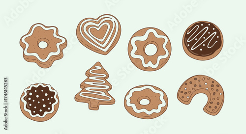 Collection of gingerbread cookies in various shapes decorated with white and brown icing on a light green background.