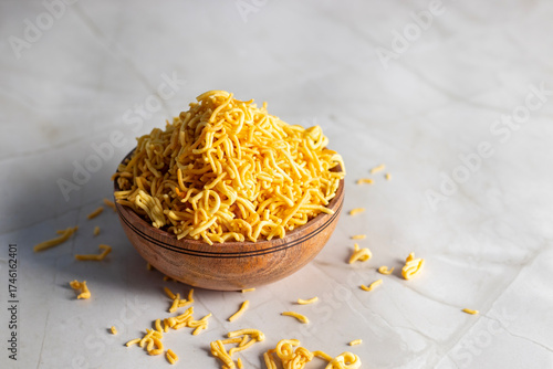 Fotografia Sev is a popular Indian crunchy snack made from gram flour, seasoned with spices, deep-fried into thin strands, and enjoyed in chaats or alone