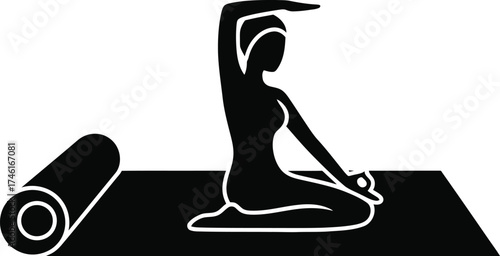 Silhouette of a woman in a yoga pose on a mat with a rolled up mat beside her