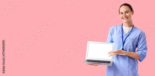 Female doctor holding lapto...