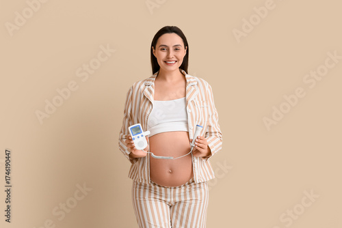 Smiling pregnant woman hold...