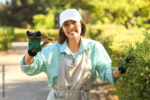 Young female gardener with ...