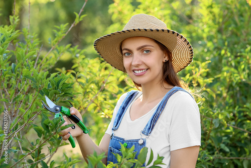 Young female gardener with ...