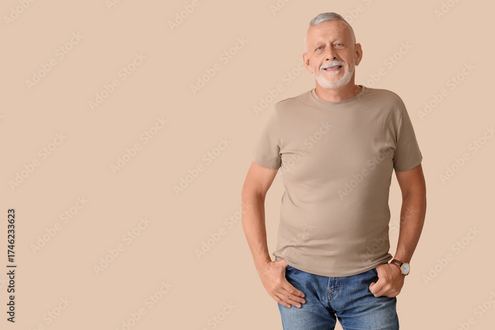 Fototapeta premium Portrait of senior man on beige background