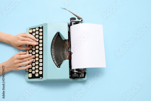 Woman typing on typewriter ...