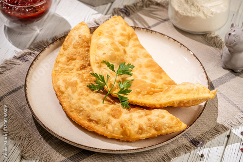 Canvastavla Crispy chebureki on a plate with parsley