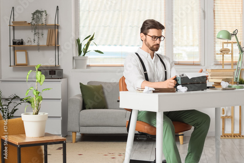 Young male writer with vint...