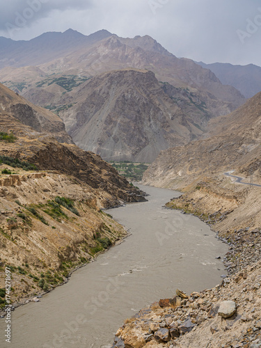 Scenic vertical mountain landscape view of Panj river valley on overcast summer day, Darvaz, Gorno-Badakhshan, Tajikistan Pamir