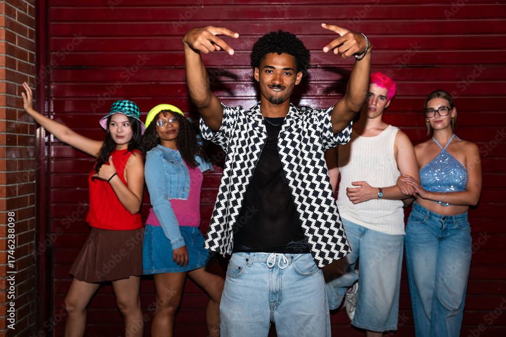 Obraz premium Multiethnic group of young friends having fun on the streets in the night - Stylish cool multiracial people wearing stylish clothing hanging out before party in a disco club