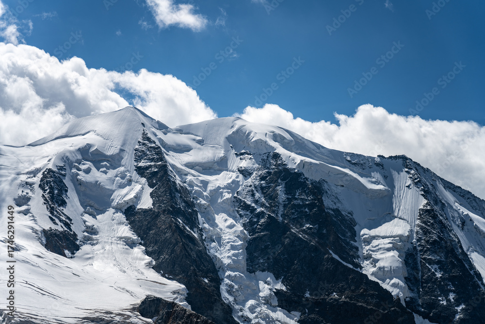 Obraz premium Piz Palu showcases its stunning glacier-covered peaks under a clear blue sky. This iconic mountain in the Bernina range resembles a striking natural fortress in Switzerland.