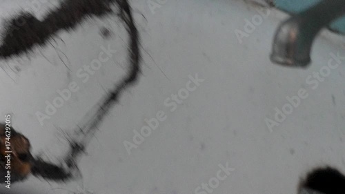 A plumber snaking the bathtub drain 