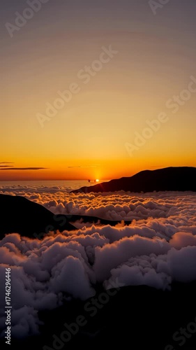 Majestic Sunrise Over a Vast Mountain Landscape with Clouds Creating a Dreamlike Atmosphere in the Golden Light of Dawn