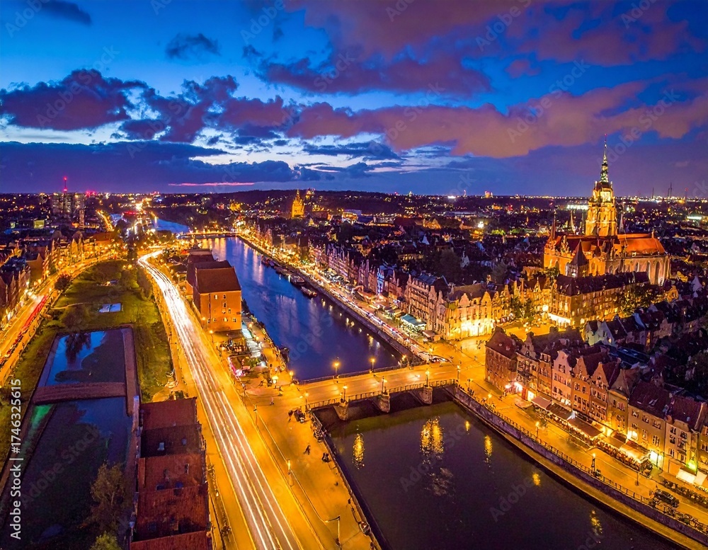 Fototapeta premium Aerial Night View of a European City with Bridges over a River and City Lights