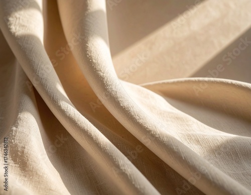 Soft folded fabric texture with warm sunlight, beige textile background for minimal design and natural aesthetic scene