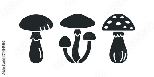 Three different dark mushroom silhouettes on white