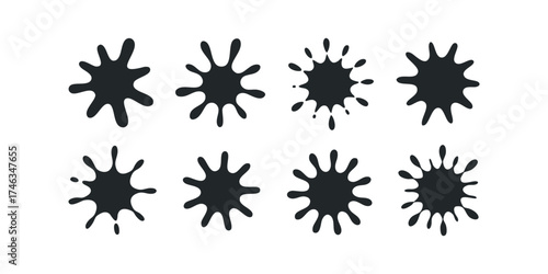 Eight Black Ink Splatters on White Surface