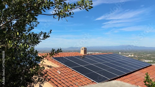 Solar electric panels, solar batteries, cell panels on house roof in Spain on blue sky background. Photovoltaic Solar array system produce clean ecological electricity, Renewable energy in Europe