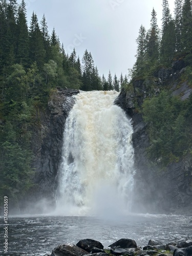 Majestic Storfossen waterfall cascading into a rocky gorge surrounded by lush greenery, Malvik, Trøndelag, Norway, August 2024