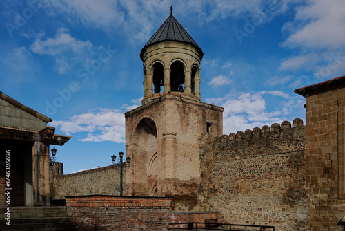 The bell tower of Svetitskhoveli Cathedral which is an Orthodox Christian cathedral located in the historic town of Mtskheta, Georgia, The cathedral  is surrounded by a stone wall