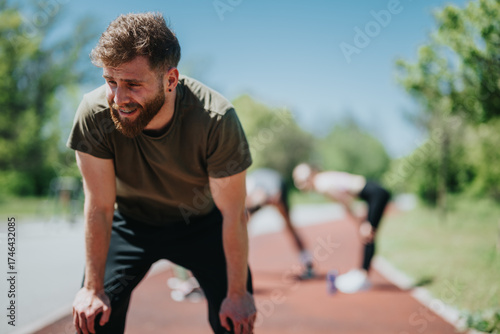 Foto Man catching his breath after outdoor activity, with focus on effort and determination